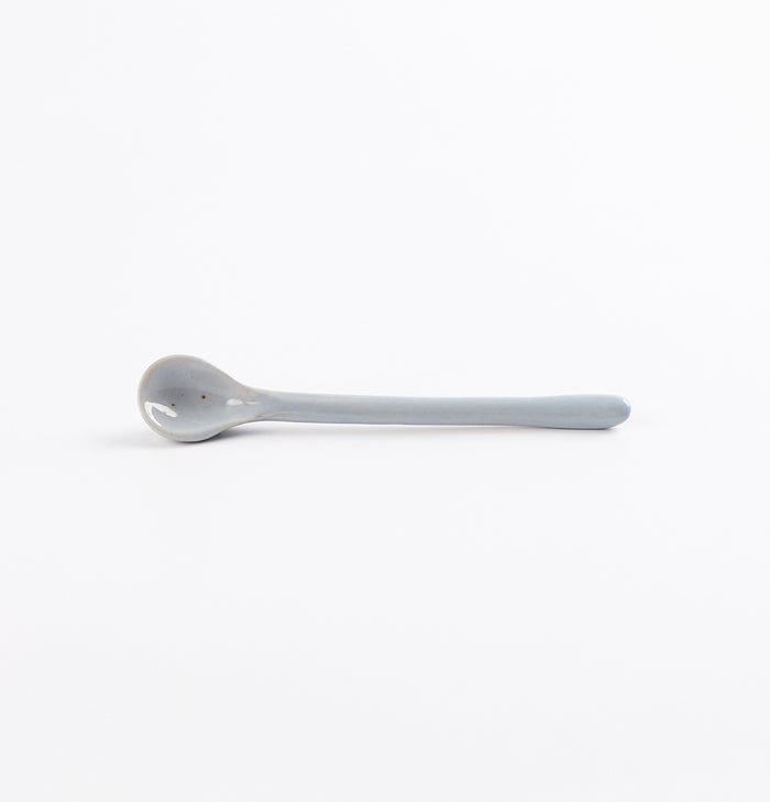 Ceramic spoon with speckles on a white background