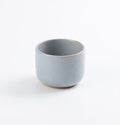 Light blue ceramic coffee cup on a white background