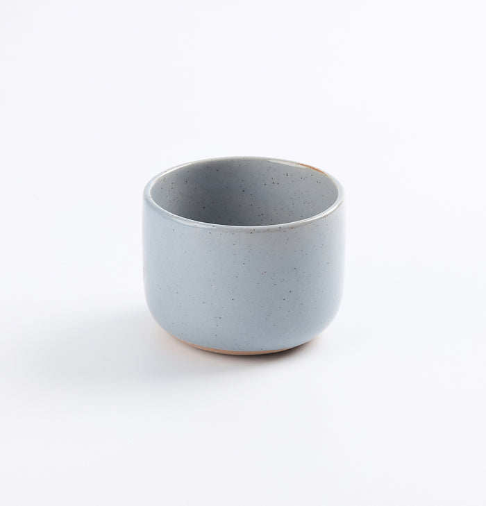 Light blue ceramic coffee cup on a white background