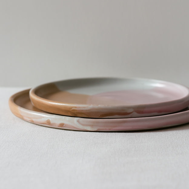 Handmade stacked plates by Palinopsia Ceramics, stoneware in pink, brown and white