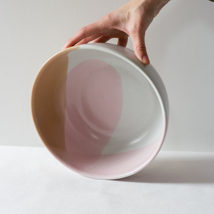 Hand holding a Handmade Colourful fruit bowl by Palinopsia Ceramics