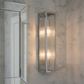 chrome bathroom anity wall light installed on a marble bathroom wall