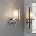 polished chrome bathroom wall light mounted on a grey wall in a bathroom
