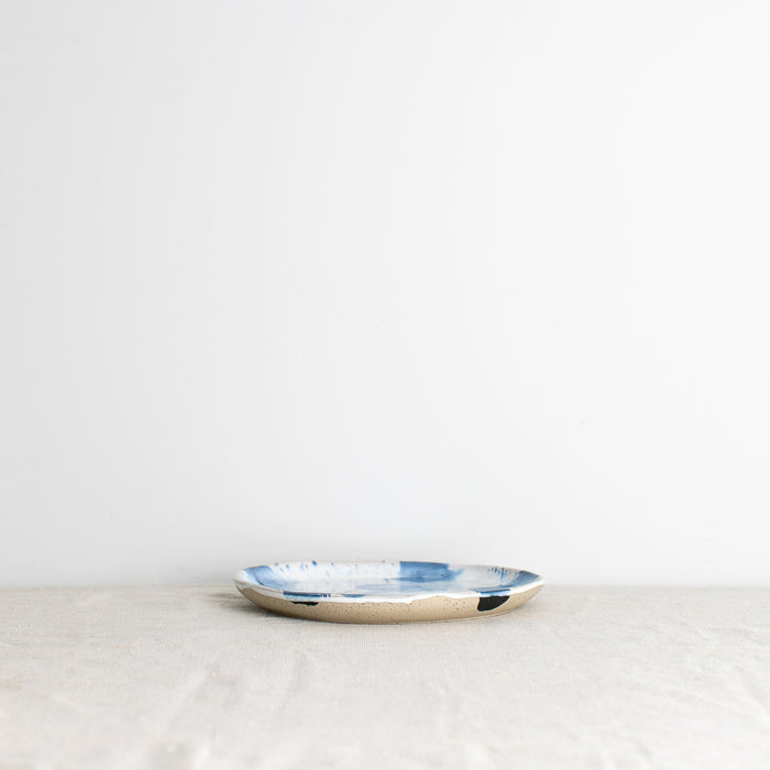 Side view of a handmade lunch plate by Palinopsia Ceramics in a blue and white design