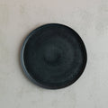 Birds-eye view of a 26cm Handmade black dinner plate with raised lip by Palinopsia Ceramics