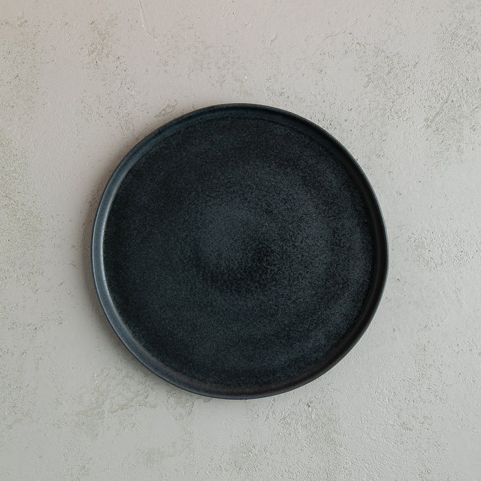 Birds-eye view of a 26cm Handmade black dinner plate with raised lip by Palinopsia Ceramics