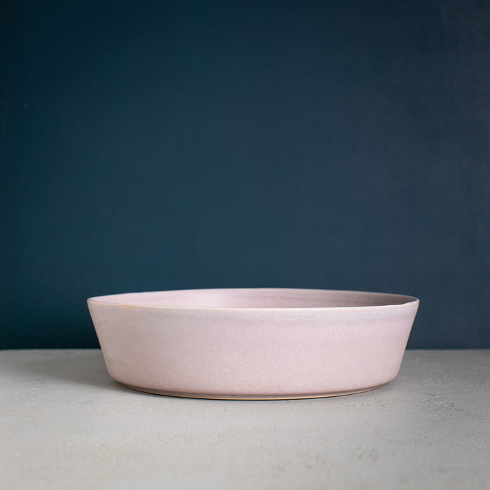Handmade stoneware fruit bowl by Palinopsia Ceramics against a navy blue background in Newcastle