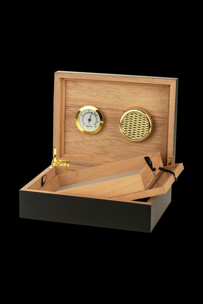 The Sigaro Personal Humidor Wood Box with Hygrometer is open, displaying a dark wood interior and a circular hygrometer on the side.