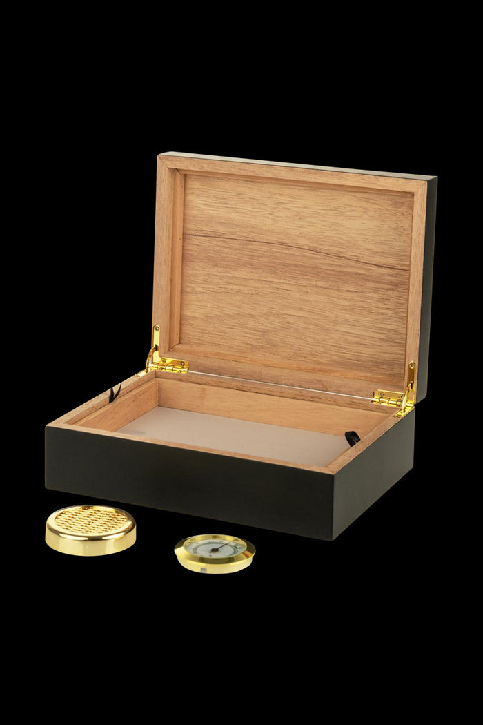 The open Sigaro Personal Humidor Wood Box with Hygrometer is shown from a high angle, revealing its wood interior and circular hygrometer.