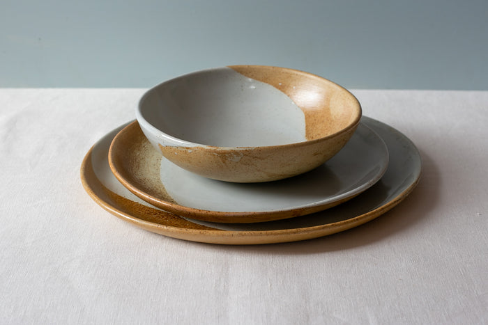 Side view of a three piece dinner set stacked