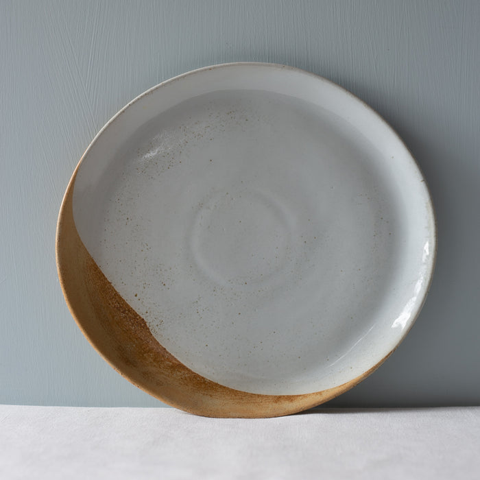 A single handmade Soda dinner plate in browns and blues