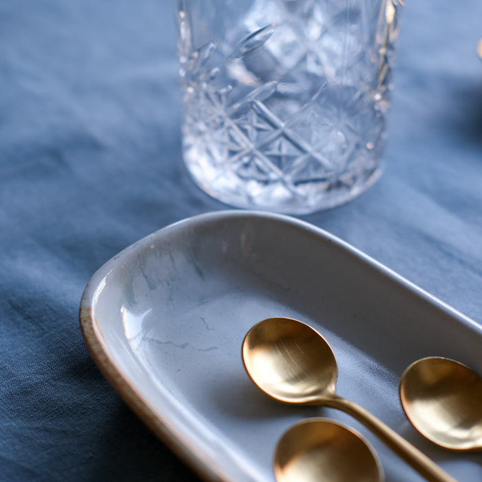 Detailed shot of a reactive glaze on a mezze dish in blue glaze, handmade stoneware by Palinopsia Ceramics