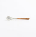 Ceramic teaspoon with two tone blue and brown colours on a white background
