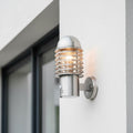 stainless steel PIR sensor outside wall light mounted on the wall outside of a modern home