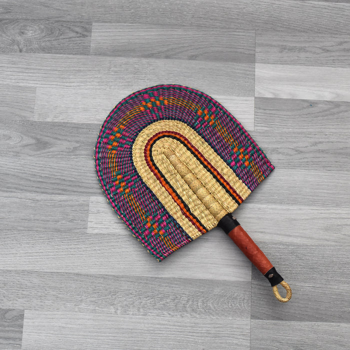 Durable handcrafted fans also known as Bolga fans, are woven from elephant grass and leather and dyed to give them a unique design or patterns. Each hand fan is a one-off piece so once it’s gone it’s gone.   The fans are perfect for keeping cool in the heat and for decorative purposes.   The handle has a loop at the end of the fan which makes it easy for hanging. You can equally mix and match a number of fans together as a piece of art display on the wall. You can also be creative in your own way.